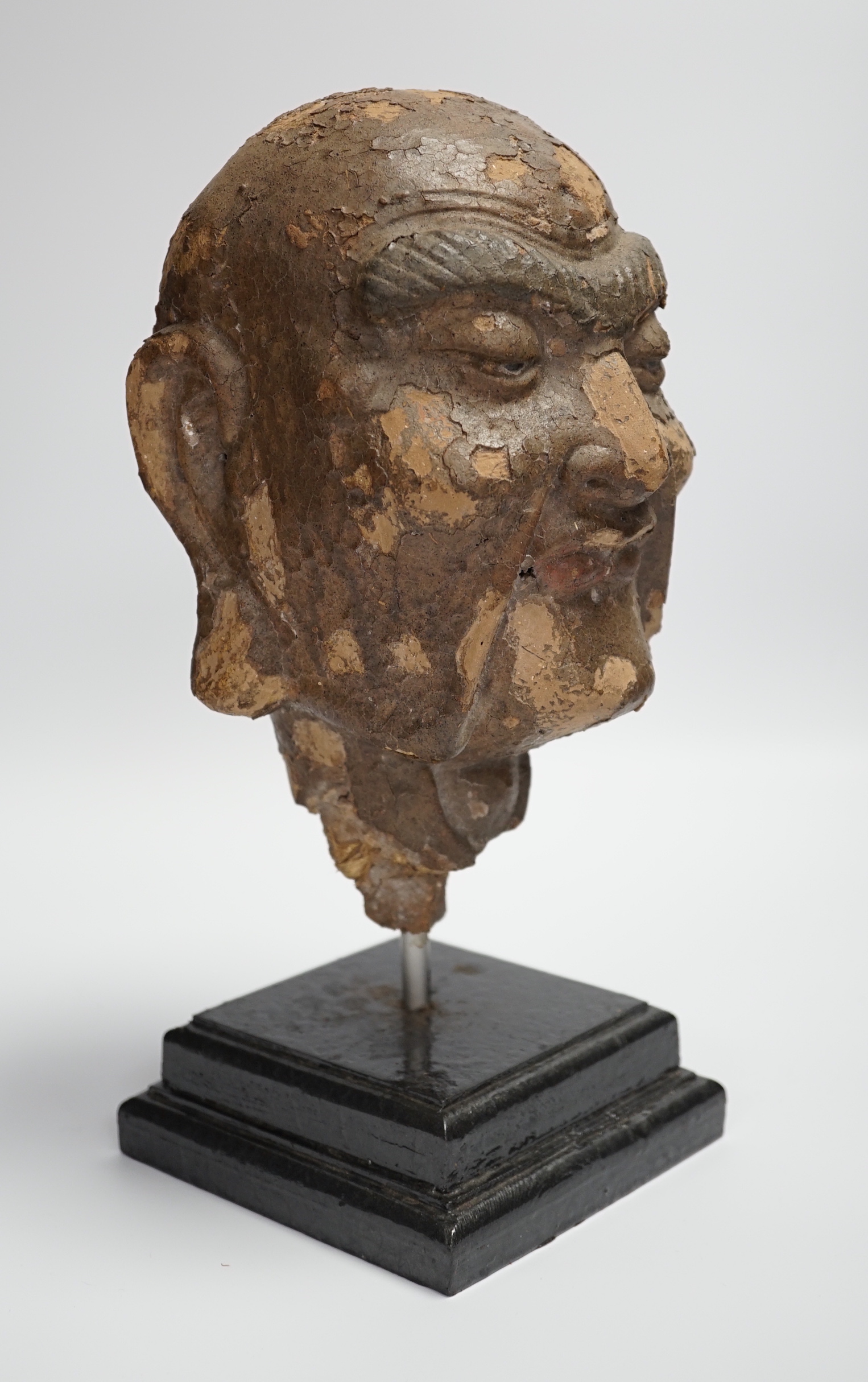 A Chinese lacquered clay head of a luohan, probably Ming dynasty, on stand, head 22cm high